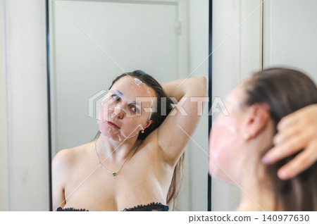 Beauty Portrait of Woman Applying Face Cream Beauty Portrait of Woman Applying Face Cream 140977630