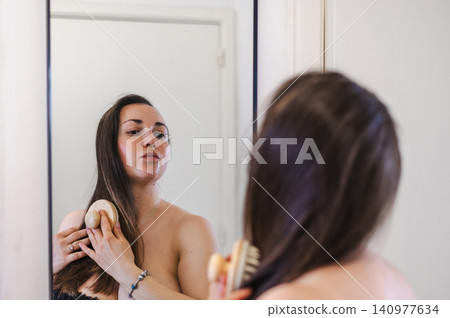 Woman Combing Hair - Daily Beauty Routine Woman Combing Hair - Daily Beauty Routine 140977634