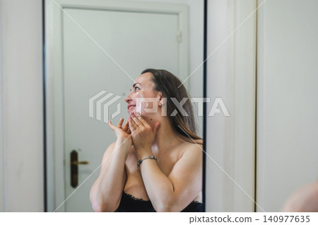 Beauty Portrait of Woman Applying Face Cream Beauty Portrait of Woman Applying Face Cream 140977635