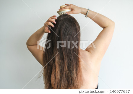 Woman Combing Hair - Daily Beauty Routine Woman Combing Hair - Daily Beauty Routine 140977637