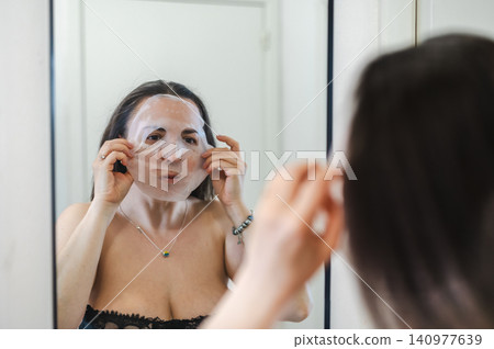 Beauty Portrait of Woman Applying Face Cream Beauty Portrait of Woman Applying Face Cream 140977639