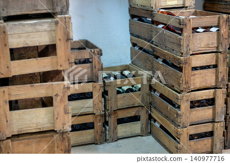 Stacked Wine Crates in Cellar Vintage Bottles Warm Light 140977716