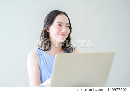 Japanese woman looking at her laptop Japanese woman looking at her laptop 140977802