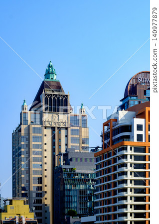 Postmodern Architecture Building with Green Spires and Modern Glass Facade Postmodern Architecture Building with Green Spires and Modern Glass Facade 140977879