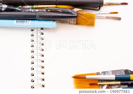 painting brush art supplies artistic tools on art book white paper background painting brush art supplies artistic tools on art book white paper background 140977981