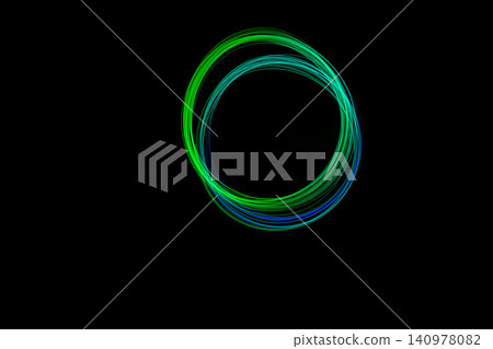 Colorful light trails form a perfect circle against a dark background, showcasing a captivating freeze effect Colorful light trails form a perfect circle against a dark background, showcasing a captivating freeze effect 140978082
