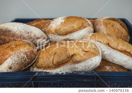 Dusty Country Loaves Piled in Crate Heavy Flour Coating Dusty Country Loaves Piled in Crate Heavy Flour Coating 140978156
