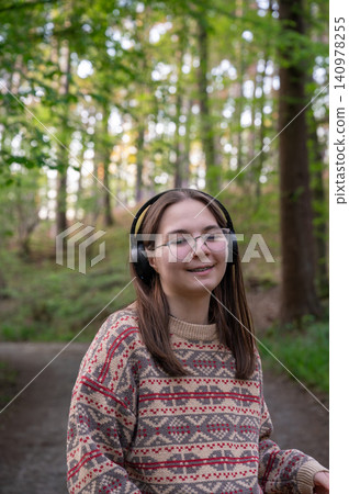 Caucasian woman practicing guided breathing on woodland path Caucasian woman practicing guided breathing on woodland path 140978255