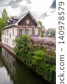 Wisteria Covered House by Canal Purple Vines Stone Facade 140978579