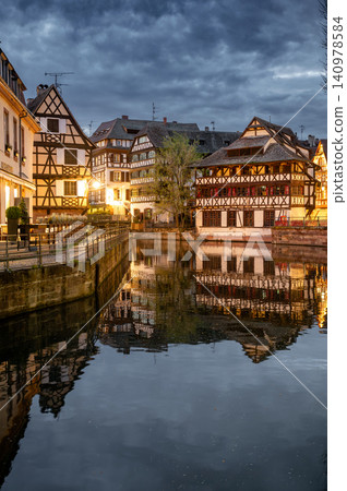 Stormy Dusk Sky Over Medieval Half-Timbered Roofs Canal Stormy Dusk Sky Over Medieval Half-Timbered Roofs Canal 140978584