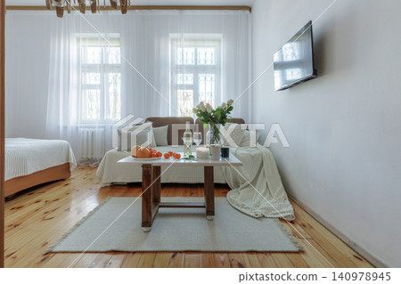 Bright Studio Apartment Living Room Interior with Table Decor Bright Studio Apartment Living Room Interior with Table Decor 140978945