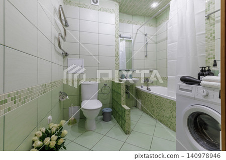Full Green Tiled Bathroom Interior with Toilet and Bath Full Green Tiled Bathroom Interior with Toilet and Bath 140978946