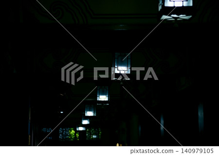 Close-up of the Chinese classical lamp hanging on the ceiling at night. Light bulb. Interior design, decoration. Lighting equipment. 140979105