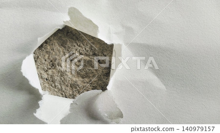 Torn White Paper Hole with Rough Gray Concrete Texture Background Torn White Paper Hole with Rough Gray Concrete Texture Background 140979157