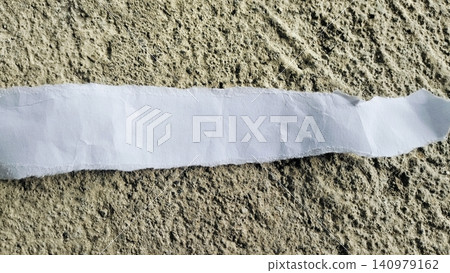 Torn White Paper Strip on Rough Gray Concrete Texture Background Torn White Paper Strip on Rough Gray Concrete Texture Background 140979162
