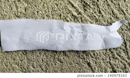 Torn White Paper Strip on Rough Gray Concrete Texture Background Torn White Paper Strip on Rough Gray Concrete Texture Background 140979163
