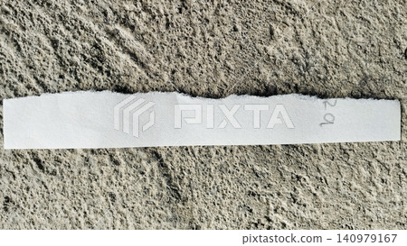 Torn White Paper Strip on Rough Gray Concrete Texture Background Torn White Paper Strip on Rough Gray Concrete Texture Background 140979167