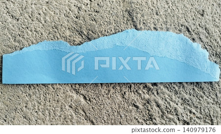 Torn Blue Paper Strip on Rough Gray Concrete Texture Background Torn Blue Paper Strip on Rough Gray Concrete Texture Background 140979176