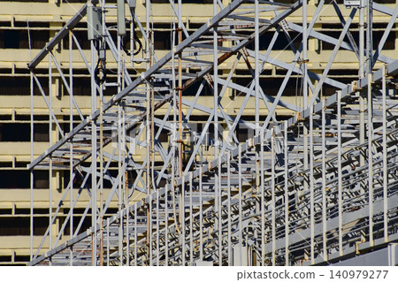 Metal scaffolding, used as temporary structure to support at the construction site. Construction concept. Construction equipment. Metal scaffolding, used as temporary structure to support at the construction site. Construction concept. Construction equipment. 140979277
