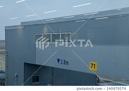 Close-up of the jet bridge in Nagoya airport, Japan. Transportation facility, airport scene. Travel concept. Close-up of the jet bridge in Nagoya airport, Japan. Transportation facility, airport scene. Travel concept. 140979574
