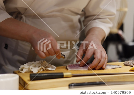 Chef Preparing Fresh Fish on Cutting Board 140979809