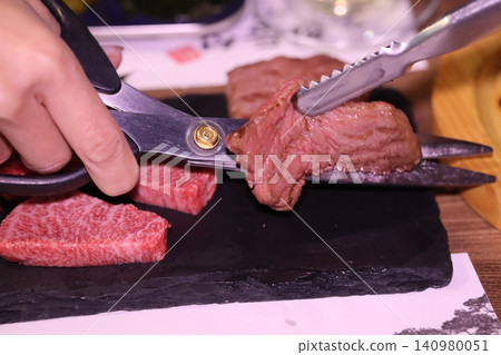Scissors Cutting Prime Beef Steak Close-Up Scissors Cutting Prime Beef Steak Close-Up 140980051