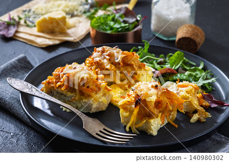 Cheesy Veggie Baked White Fish on a plate Cheesy Veggie Baked White Fish on a plate 140980302