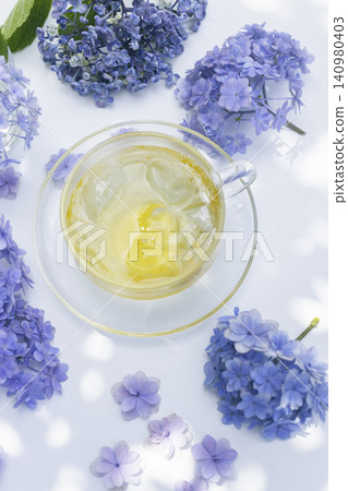 Blue hydrangeas and iced herbal tea – a refreshing image for summer tea time. Blue hydrangeas and iced herbal tea – a refreshing image for summer tea time. 140980403