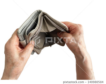 An elderly woman's hand turning over an empty wallet. 140980584