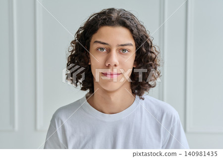 Close up of calm teen boy looking at camera Close up of calm teen boy looking at camera 140981435