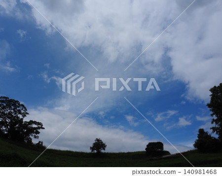 Blue sky and clouds stretching across the hilltop Blue sky and clouds stretching across the hilltop 140981468
