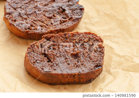 A close-up shot of delicious homemade chocolate rusks on parchment paper 07 A close-up shot of delicious homemade chocolate rusks on parchment paper 07 140981590