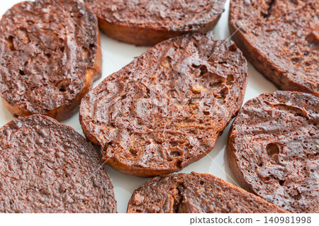 A close-up shot of delicious homemade chocolate rusks on a white plate. (25) A close-up shot of delicious homemade chocolate rusks on a white plate. (25) 140981998