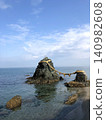 The scenery of Meotoiwa (Husband and Wife Rocks) standing against a blue sky and calm sea (Ise City, Mie Prefecture) 140982608