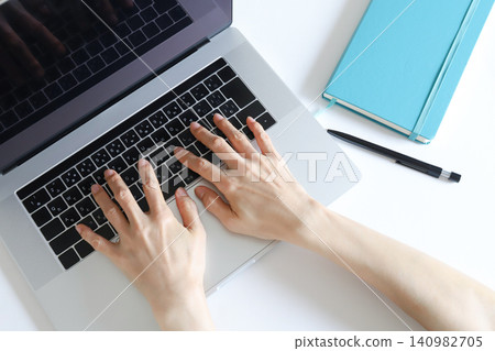 Hands typing on a laptop Hands typing on a laptop 140982705