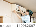 Female worker cleaning the house to clean the air conditioner 140982807