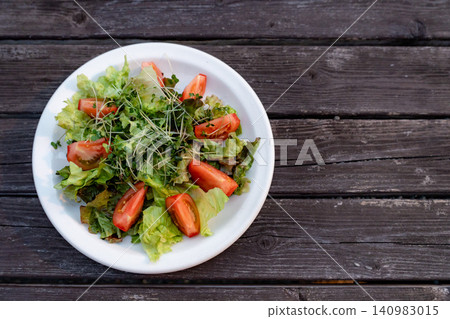Salad on a wooden table Salad on a wooden table 140983015