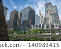 高聳的塔式起重機矗立在一片在建建築群中。 140983415