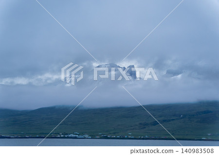 Snowy Mountains and Clouds over Hofn, Iceland Snowy Mountains and Clouds over Hofn, Iceland 140983508