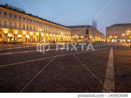 Turin, piedmont, italy. November 20, 2024. Piazza san carlo, a historic square in turin, italy, illuminated by streetlights and building lights in the fog 140983690