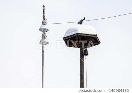 modern and old snow-covered wooden alarm tower modern and old snow-covered wooden alarm tower 140984183