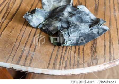 used sandpaper on teak wooden table close-up used sandpaper on teak wooden table close-up 140984224