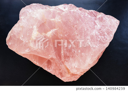 natural rose quartz rock close-up on black natural rose quartz rock close-up on black 140984239