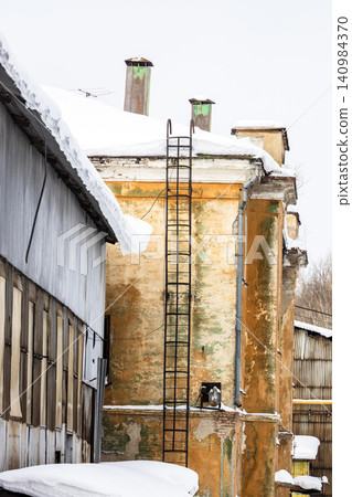 abandoned factory building with fire escape abandoned factory building with fire escape 140984370