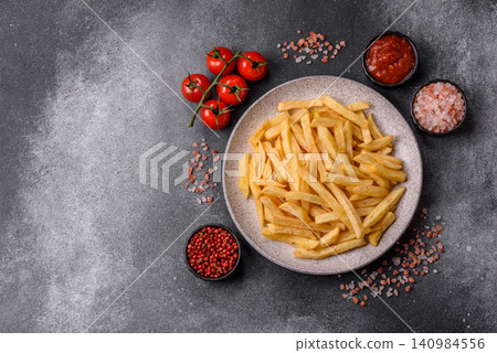Golden French fries fried with salt and spices, unhealthy takeaway food. French fries Golden French fries fried with salt and spices, unhealthy takeaway food. French fries 140984556
