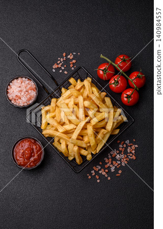 Golden French fries fried with salt and spices, unhealthy takeaway food. French fries Golden French fries fried with salt and spices, unhealthy takeaway food. French fries 140984557