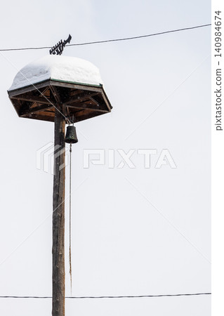 snow-covered old wooden tower with fire alarm bell snow-covered old wooden tower with fire alarm bell 140984674