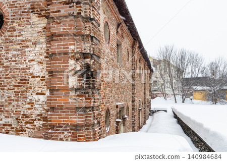 snowdrifts around brick building during snowfall snowdrifts around brick building during snowfall 140984684