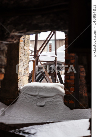 snow-covered broken window on abandoned factory snow-covered broken window on abandoned factory 140984812