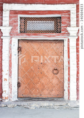 closed antque painted metal door in old building closed antque painted metal door in old building 140984833